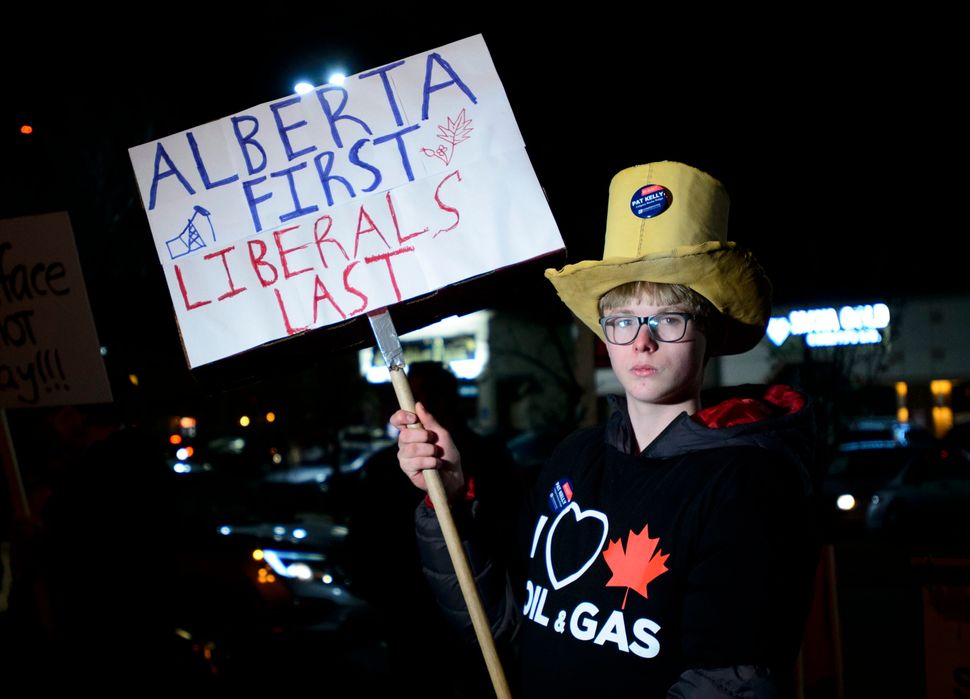 A protester rallies outside Liberal Leader Justin Trudeau's rally in Calgary on Oct. 19, 2019.