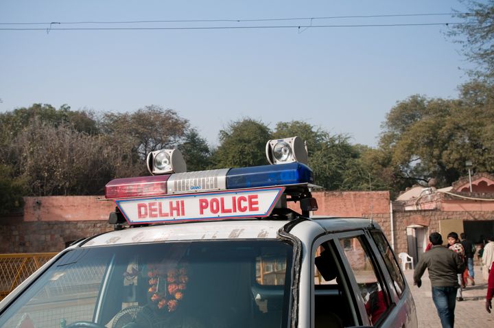"New Delhi, India - January 16, 2011: A Police car in New Delhi, India. Close-up photo of the windscreen and siren. It is decorated with flower bands and is parked near a tourist attraction. Delhi is under a high alert level especially near tourist sites due to terrorist threats. Delhi\'s police force is one of the largest in the world with over 80.000 officers."