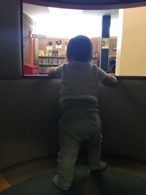 The author's son inside his favourite place, the library's rocket ship.