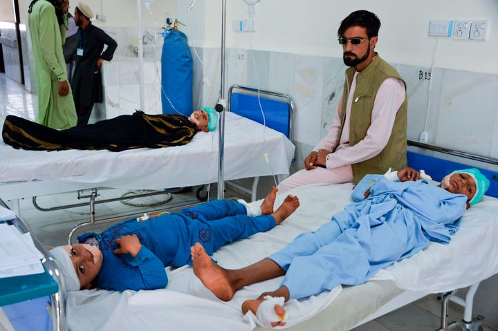 At least three people were killed and about 20 children wounded when a Taliban truck bomb detonated on Oct. 16 near a rural police station and partially destroyed a nearby religious school, Afghan officials said. Children are seen receiving medical treatment in a hospital.