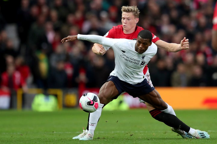 Liverpool's Georginio Wijnaldum, right, fights for the ball with Manchester United's Scott McTominay during the English Premier League soccer match between Manchester United and Liverpool at the Old Trafford stadium in Manchester, England, Sunday, Oct. 20, 2019. (AP Photo/Jon Super)