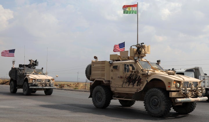 A convoy of U.S. military vehicles arrives near the Iraqi Kurdish town of Bardarash after withdrawing from northern Syria on