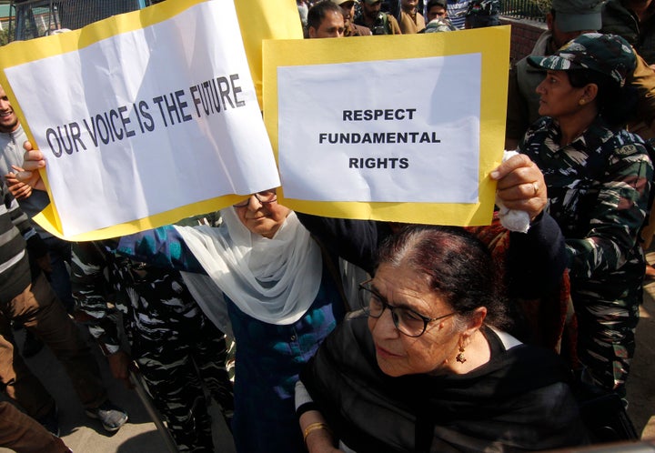 Members of 'Women of Kashmir' a civil society group hold placards as they protest against the revocation of Article 370 in Srinagar,Kashmir on October 15, 2019.