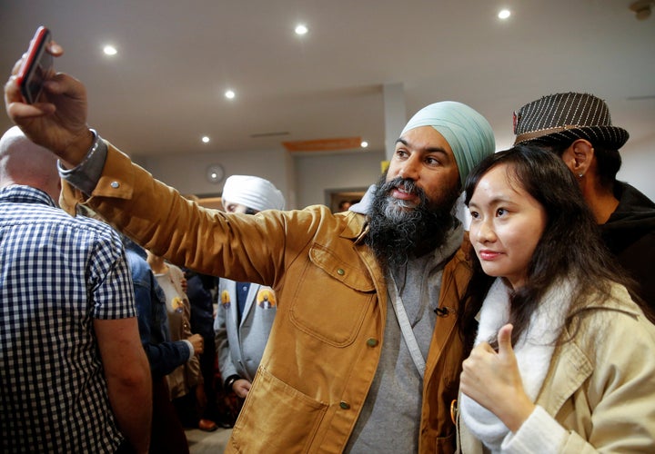 NDP Leader Jagmeet Singh takes a selfie with a supporter at the party election office in Burnaby, B.C. on Oct. 21, 2019.