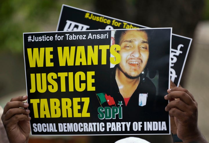 An Indian man holds a placard condemning the mob lynching of Muslim youth Tabrez Ansari in Jharkhand.