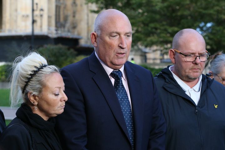 Spokesman Radd Seiger flanked by Harry Dunn's mother Charlotte and father Tim 