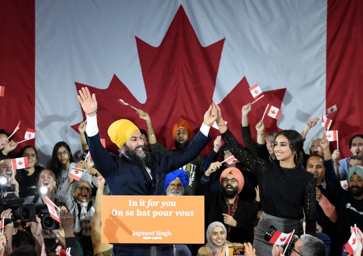 NDP leader Jagmeet Singh and his wife Gurkiran Kaur wave to supporters on stage at NDP election headquarters in Burnaby, B.C. on Monday, Oct. 21, 2019.