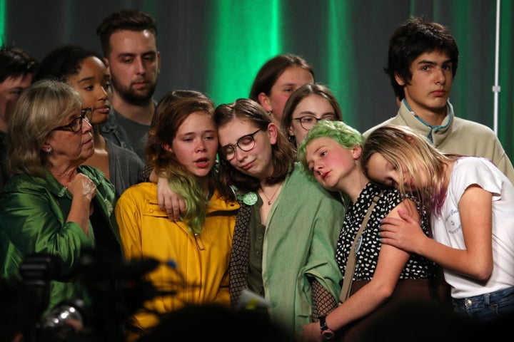 Green Party leader Elizabeth May consoles young supporters in Victoria on Oct. 21, 2019.