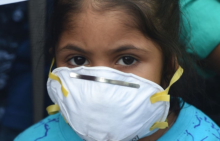 A girl wears a face mask to protect against air pollution in New Delhi on November 6, 2018. 