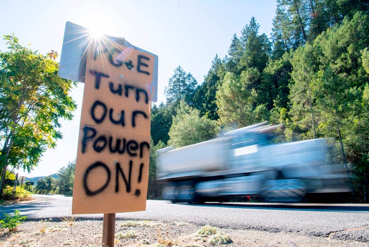 A sign calling for PG&E to turn the power back on is seen on the side of the road during a statewide blackout in Calistoga, California, on Oct. 10.