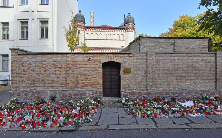 Flowers and candles are placed next to the door of the Halle synagogue, days after a right-wing extremist attack on the congregation. 