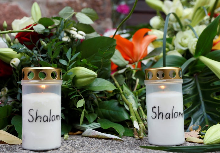 Flowers and candles are seen outside the synagogue in Halle, Germany, October 10, 2019, after two people were killed in a shooting.