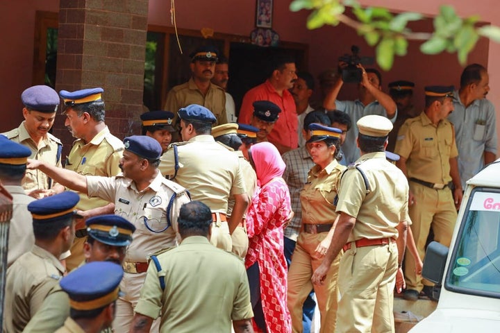 Police with Jolly Joseph at the Koodathayi house.