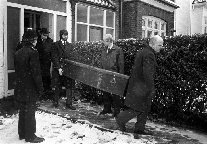 A coffin being taken from the house in Cranley Gardens, Muswell Hill under police supervision