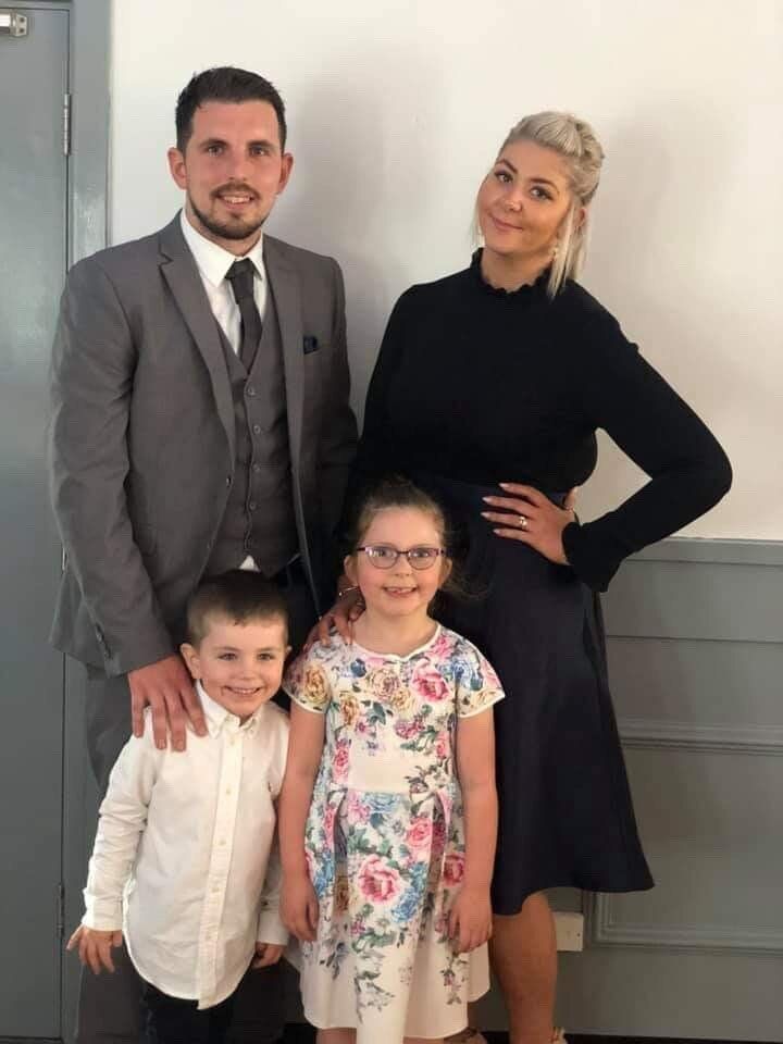Emily, with her partner and two children