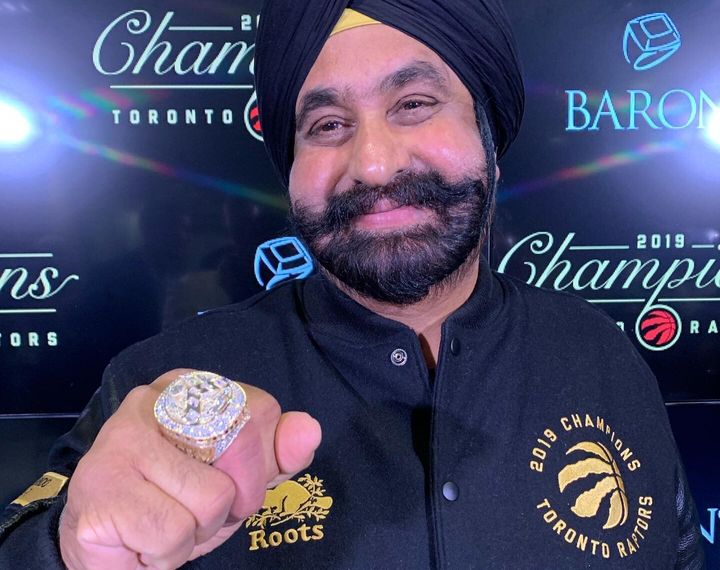 Toronto Raptors "Superfan" Nav Bhatia smiles while posing with his customized NBA championship ring in Toronto on Tuesday.
