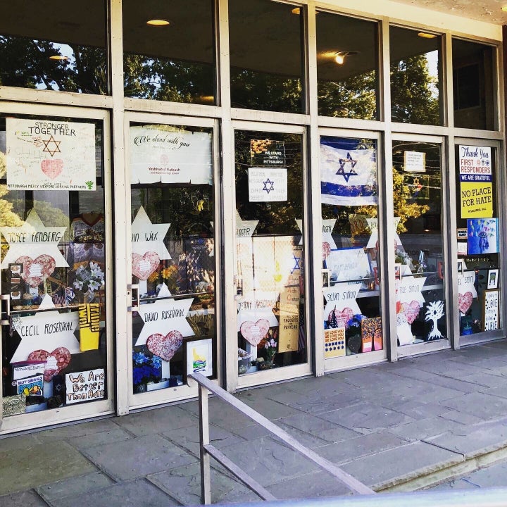 The doors of the Tree Of Life synagogue covered in posters and signs related to the mass shooting.