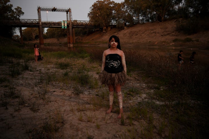 Ngiyaampaa girl Punta Williams poses for photographs on the dry riverbed before performing at Yaama Ngunna Baaka Corroboree Festival on the banks of the Darling River in Wilcannia, New South Wales,