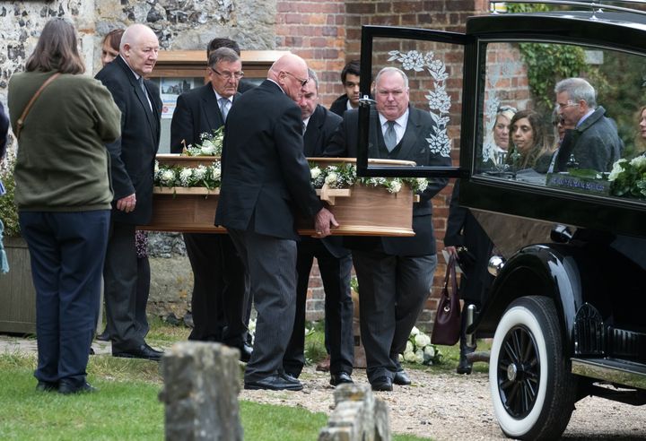 Squire's casket being placed in the hearse during her funeral at St Lawrence's Church in West Wycombe, Buckinghamshire