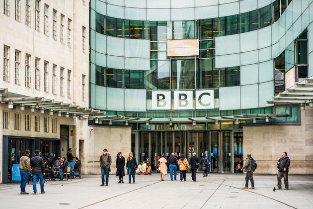 London, UK - People outside the main entrance to the BBC's Broadcasting House building in central London.