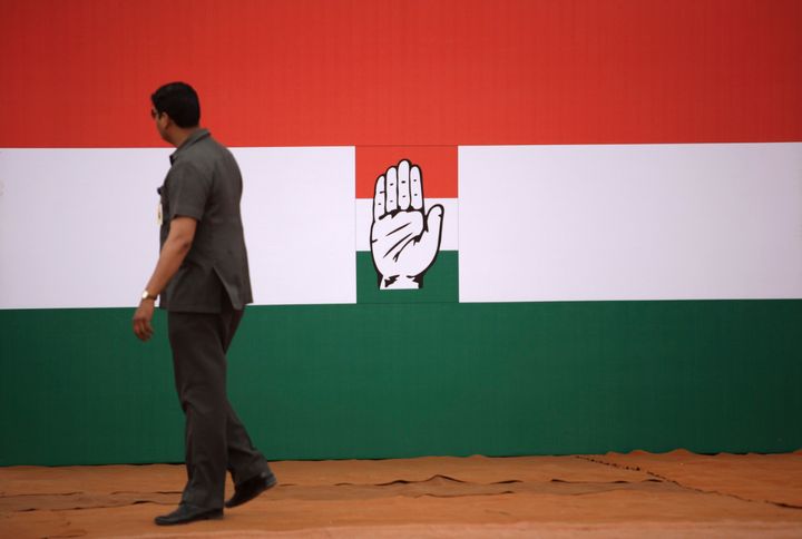 An Indian security man walks near a Congress party symbol in this file photo. 