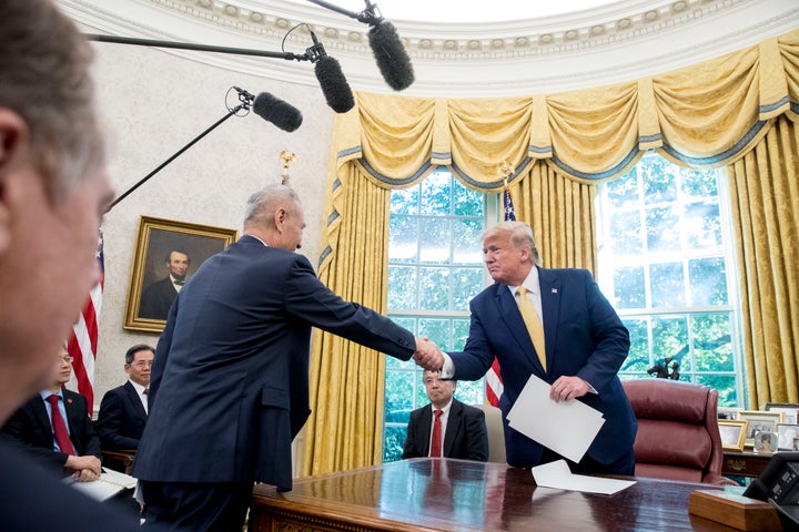 President Donald Trump shakes hands with Chinese Vice Premier Liu He after being given a letter in the Oval Office of the White House in Washington, Friday, Oct. 11, 2019.