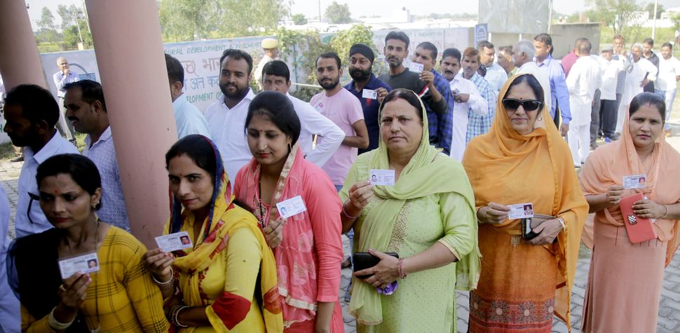 Panches and Sarpanches stand in a queue to cast their vote for Block Development Council (BDC) election, at Suchetgarh, in Jammu.