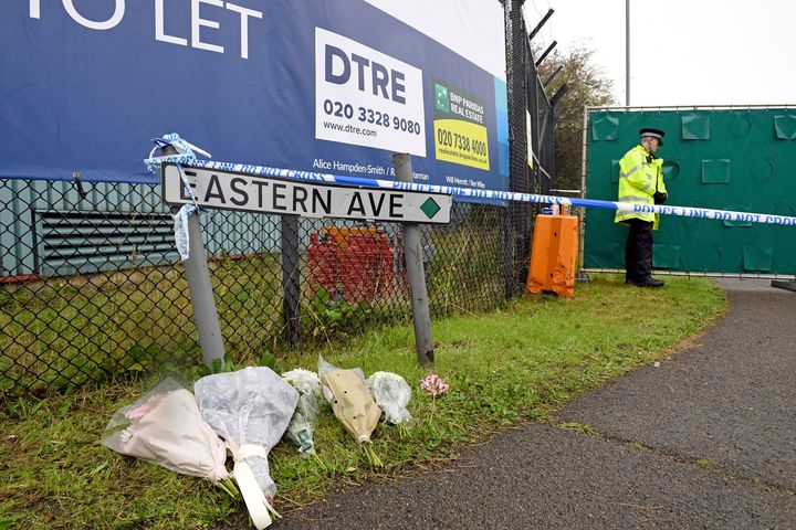 Floral tributes at the Waterglade Industrial Park in Thurrock, Essex, England Thursday Oct. 24, 2019 the day after 39 bodies were found inside a truck on the industrial estate. British media are reporting that the 39 people found dead in the back of a truck in southeastern England were Chinese citizens. (Stefan Rousseau, PA via AP)