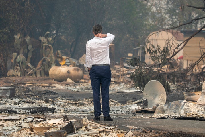 Gov. Gavin Newsom surveys a home destroyed in the Kincade fire on Oct. 25, 2019, in Geyserville, California.