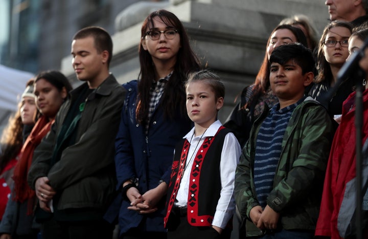 Some of the 15 young people who are parties to a lawsuit filed against the federal government for contributing to high levels of greenhouse gas emissions and dangerous climate change are seen at a press conference, in Vancouver on Friday.