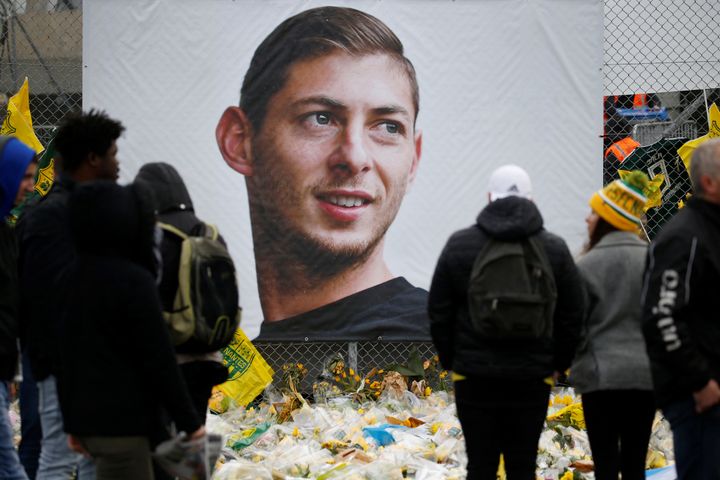 Fans looking at tributes left outside the Nantes stadium in memory of Emiliano Sala.