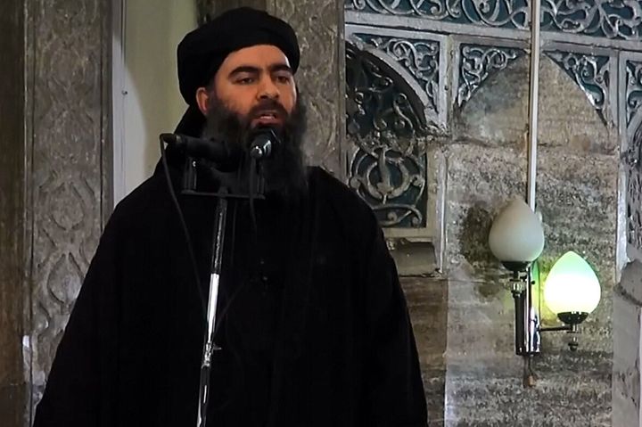 An screenshot taken from a video released on July 5, 2014 by Al-Furqan Media shows alleged Islamic State of Iraq and the Levant (ISIL) leader Abu Bakr al-Baghdadi preaching during Friday prayer at a mosque in Mosul.
