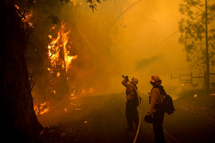 Firefighters battle a wildfire called the Kincade Fire on Chalk Hill Road in Healdsburg, Calif., Sunday, Oct. 27, 2019. (AP Photo/Noah Berger)