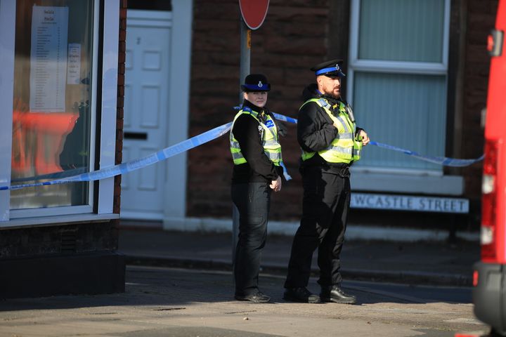 Police community support officers man a cordon near to Dixon's Chimney in Carlisle, Cumbria. 