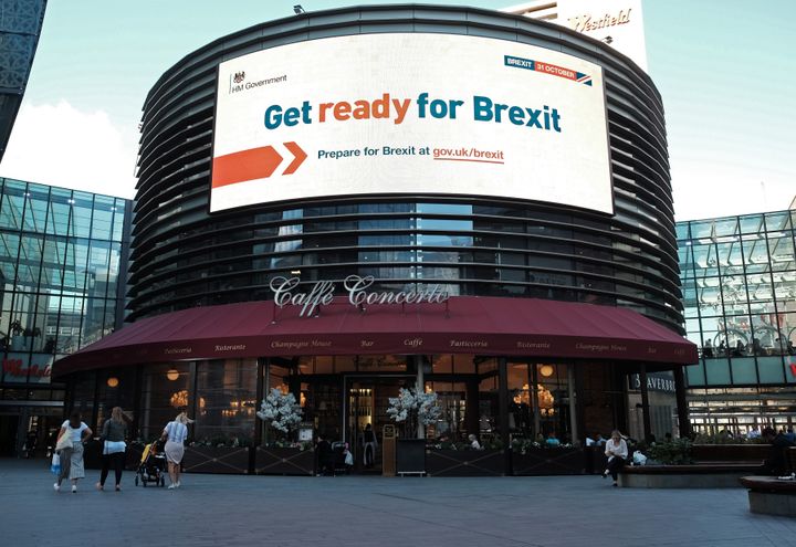 An electronic display showing a 'Get Ready For Brexit' Government advert in London.