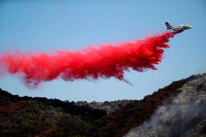 A plane drops fire retardant as the Getty fire burns Monday in Los Angeles' Mandeville Canyon.