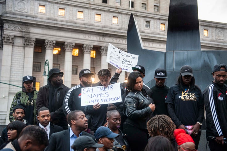 People hold signs in New York City's Foley Square during the protest.