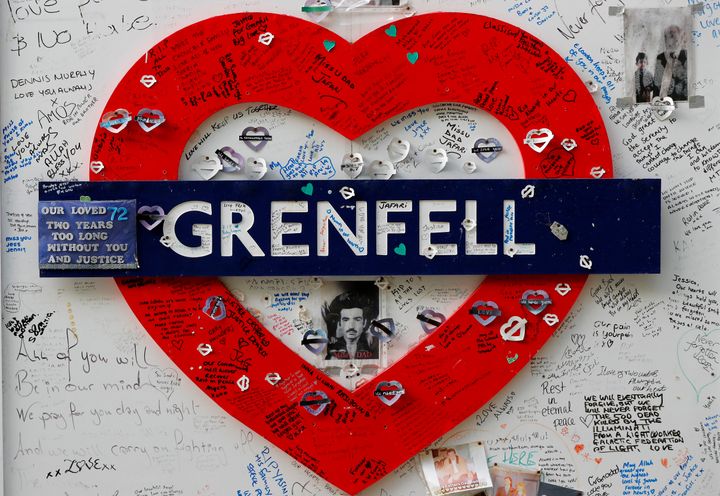 Messages are written on a construction wall near Grenfell Tower in London