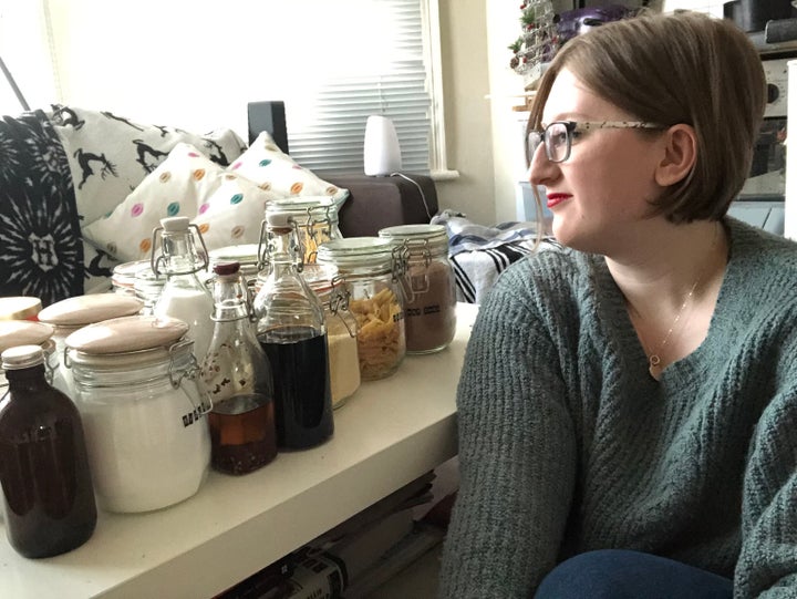 Ellie Pilcher with jars of grocery products she purchased from zero waste shops.