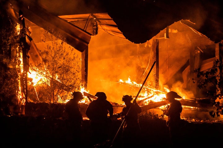 Firefighters tend to a structure lost during the Kincade fire in Healdsburg on Tuesday night. 