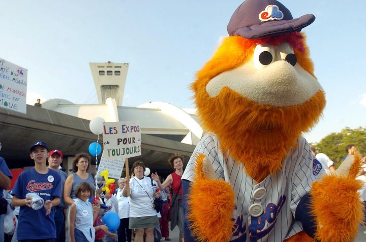 Expos fans cheer with team mascot Youppi! before a game against the Philadelphia Phillies in Montreal on Sept. 25, 2004.
