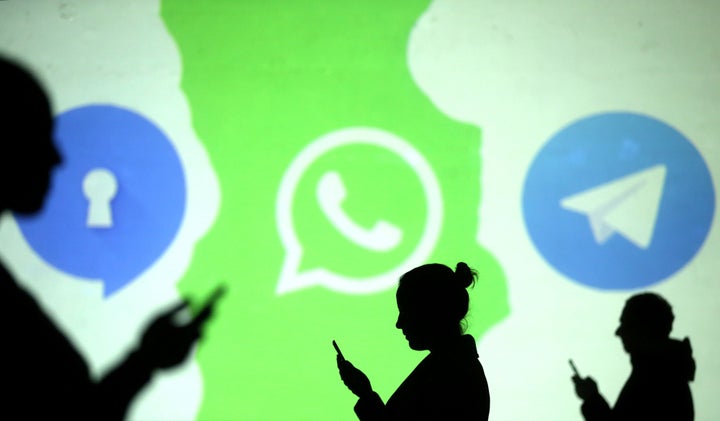 Silhouettes of mobile users are seen next to logos of social media apps Signal, Whatsapp and Telegram. Representational Image.