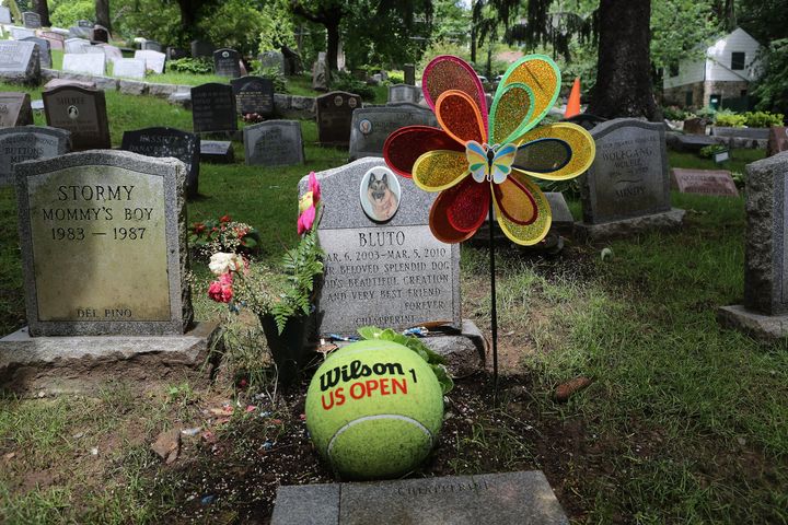 A pet, his grave festooned by its owner, lies buried at the Hartsdale Pet Cemetery.