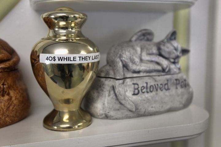 Urns designed to carry pets' ashes are displayed for sale.