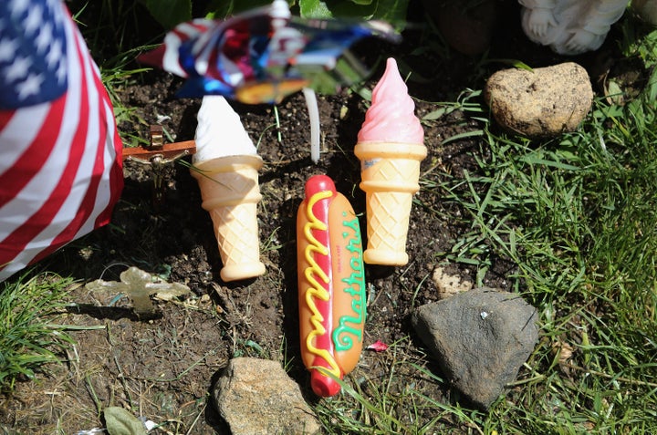 Adornments lie at the foot of a tombstone at the Hartsdale Pet Cemetery. Pet owners also have the option of eventually having their own ashes buried in the plot, alongside their pets.