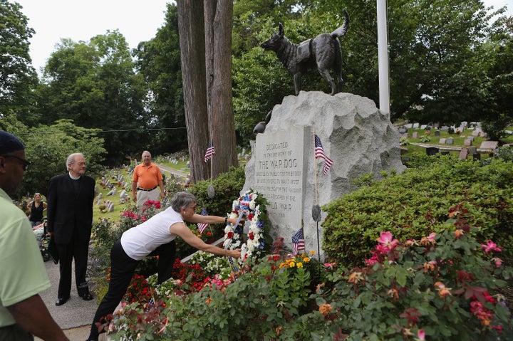 A wreath of flowers is laid at the cemetery's War Dog Memorial during the annual memorial service for military working dogs on June 10, 2012.