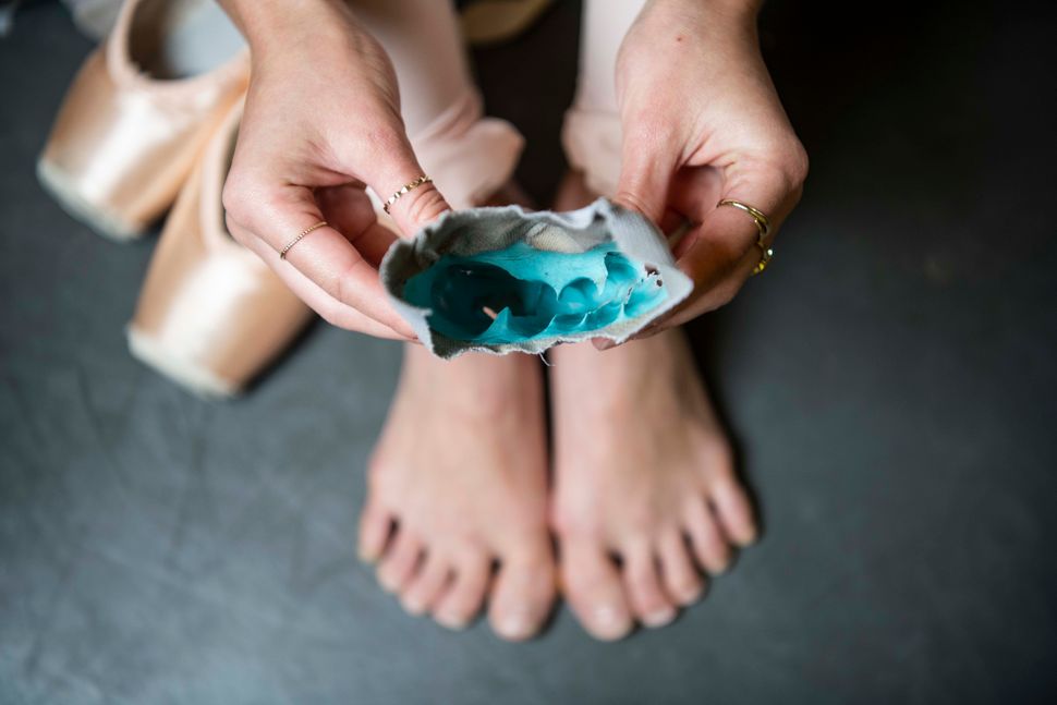 Molded toe pads inside the pointe shoes. 