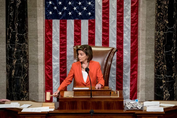 House Speaker Nancy Pelosi wields the gavel Thursday as the House votes 232-196 to pass a resolution allowing the impeachment procedure to move forward.