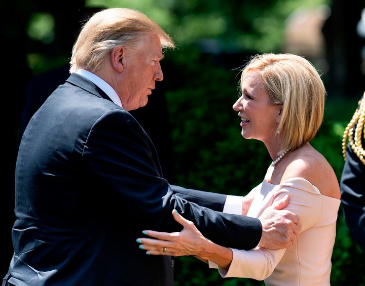 President Donald Trump talks to Paula White after an event to celebrate a national day of prayer in the Rose Garden of the White House on May 2, 2019.