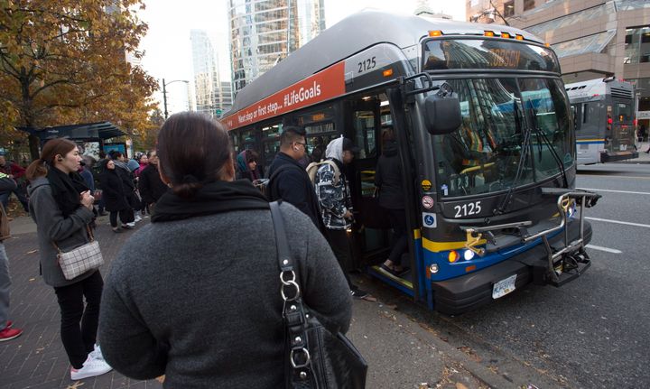 Passengers board a bus in downtown Vancouver, Friday, November, 1, 2019. 